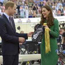 The Duchess holds a tiny Lycra shirt gifted to Prince George